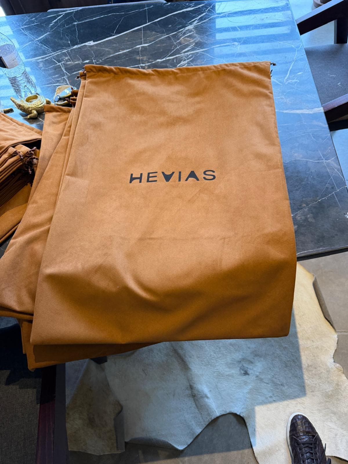 Hevias drawstring dust bags gathered on a table